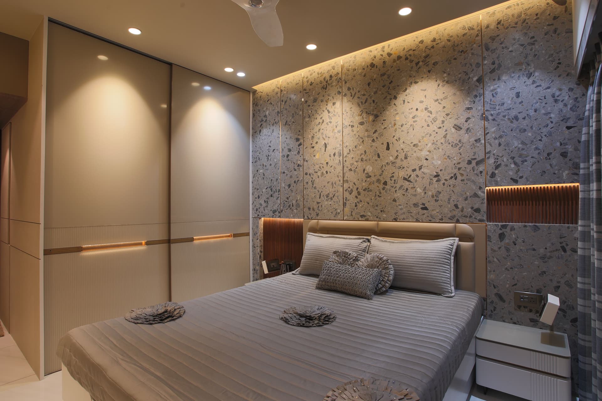 Master bedroom interior with custom wardrobe, upholstered headboard and layered ambient lighting by Furniluxe, Thane